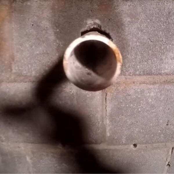 Discharge pipe through foundation wall